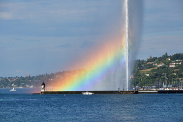 Naklejka na ściany i meble Switzerland, Geneva. A rainbow over the Jet d'Eau (Water-Jet) on Lake Geneva. August 15, 2022.