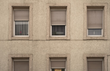 Dreary dirty façade with sign for rent in French language a louer
