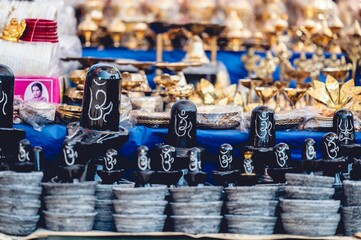 Hindu idols and golden decorations for sale in a local Indian market