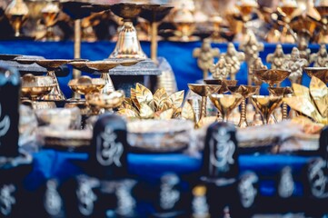 Closeup shot of traditional golden and copper Indian decorations for sale in a local market