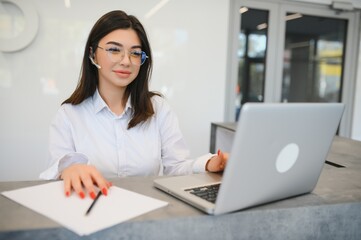 Portrait of receptionist at desk in lobby