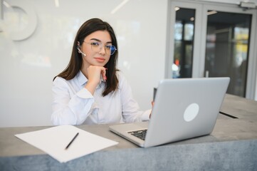 Portrait of receptionist at desk in lobby