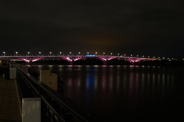 Night view of the bridge over the river with illumination