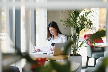 Smiling girl student study online with skype teacher, happy young woman learn language listen...