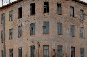 Fototapeta premium View of an old abandoned dilapidated apartment building