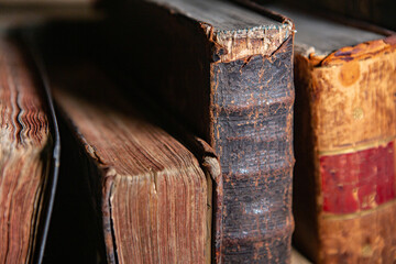 Very old books sitting on the shelves in the library. Books as a symbol of knowledge.