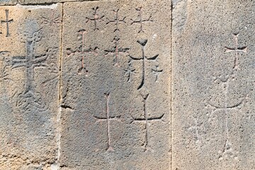 Armenia, Amberd, September 2022. Christian crosses on the ancient wall of the temple.