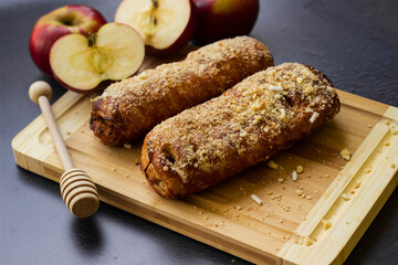Homemade puff pastry roll with apple and walnuts. Puff pastry apple pastry for dessert