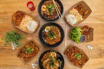Set of Asian food recipes in black bowls and street food containers, various ramens with meat, miso soup and noodles, chicken curry and roasted duck