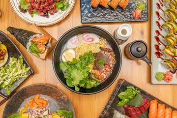 Set of Asian Japanese food recipes in dishes of different with fish sashimi, ramen with meat and noodles, sea bass ceviche and assorted sushi