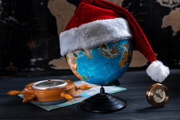New year travel concept. Globe with santa claus hat