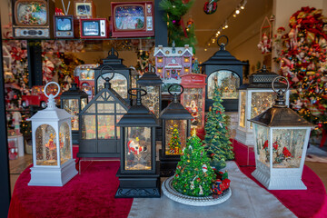 Cute Christmas lanterns, with artificial snow and glitter swirling in the water inside the lantern