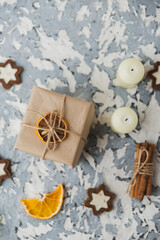 Christmas still life on the windowsill. Concrete background, gifts, candles and garlands