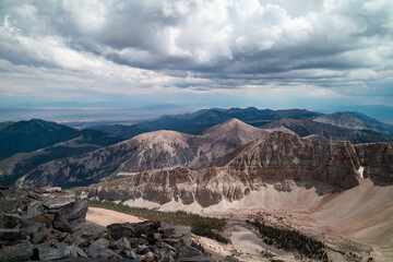 The Snake Mountain Range in Nevada viewed looking south from the summit of Wheeler Peak in Great Basin National Park. Stormy clouds are in the sky on a summer day..