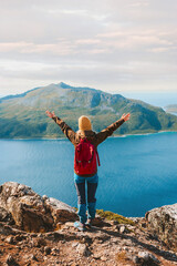 Traveler with backpack in Norway hiking success raised arms Travel adventure active vacations...