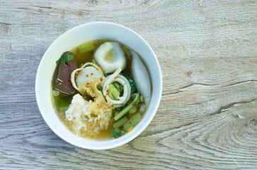 noodles flour made from fish meat topping ball and morning glory in soup on bowl  