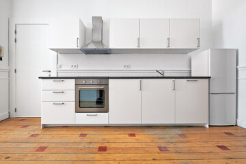 Empty apartment with modern kitchen and designed hardwood