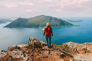 Backpacker woman hiking on cliff in Norway Travel lifestyle adventure active vacations outdoor...