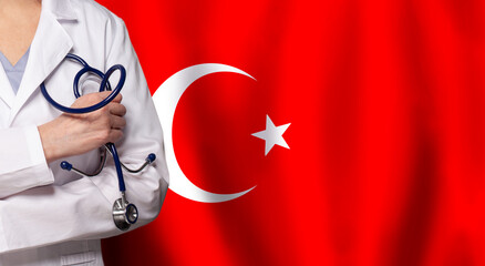 Turkish medicine and healthcare concept. Doctor close up against flag of Turkey background