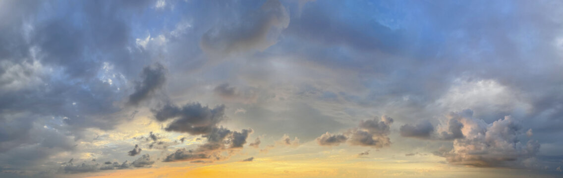 Panorama of Dramatic vibrant color sky with beautiful cloud of sunrise or sunset. Panoramic cloudscape background