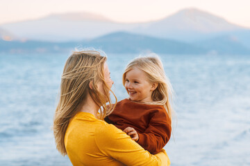 Mother and child daughter walking outdoor family travel lifestyle vacations cute baby with mom happy emotions lake landscape - 546853968