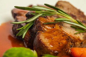 gourmet ham steak with vegetables and sause on white background
