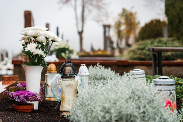 Decorated graves on Cemetery just before All Saints Day.Foggy day.