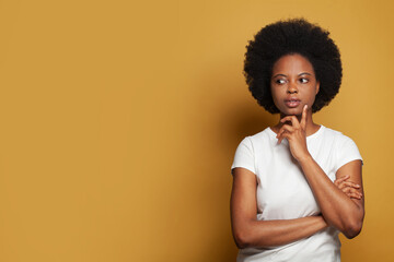 Black woman student thinking on bright yellow banner background with copy space