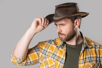 west man with cowboy hat isolated on grey background. west man in cowboy hat in studio.