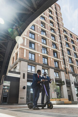Fototapeta premium Meeting of two partners of black African American businessman in suits and glasses outdoors in a city block. Friendship and business partnership