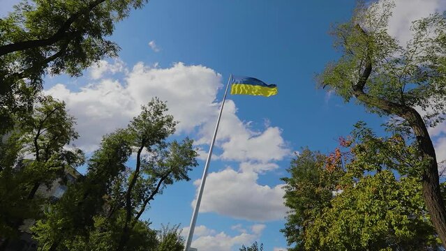 Ukraine flag against the sky. Ukrainian flan in the wind. The flag of Ukraine flutters in the wind.