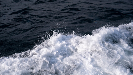 Abstract blue sea water with white foam for background, nature background concept, sea foam texture, with space for text with blanks.