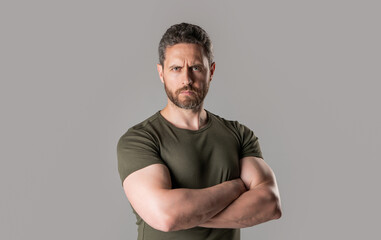 mature muscular guy isolated on grey background. mature muscular guy with stubble in studio