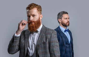 elegant gentlemen in formal tux suit, selective focus. tux gentlemen isolated on grey background.