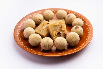 Rava barfi with laddu also called sooji burfi and Laddoo. Indian Sweet made with semolina