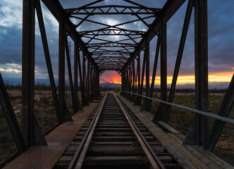 Sunset on the old railway iron bridge