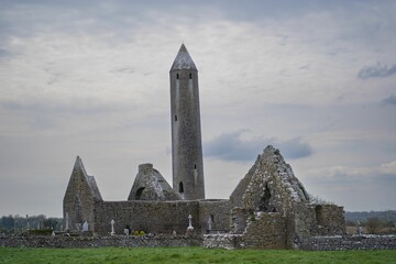 Cloudy sky over the Kilmacduagh monastery in south County Galway, near Gort, Ireland - obrazy, fototapety, plakaty