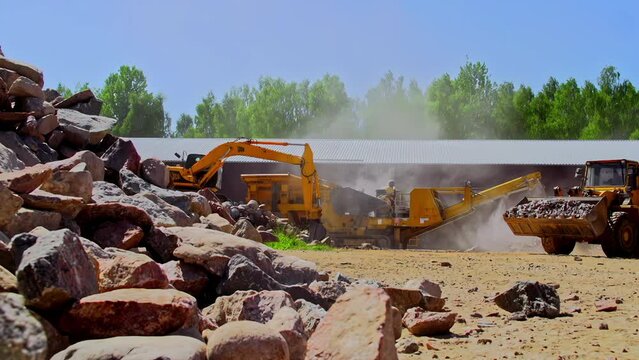 JCB Bulldozer engaged in collecting stones, crushing it and dumping it on the other side, static shot