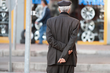 a stylish elderly man dressed in a traditional Turkish costume.