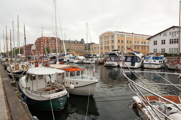 beautiful harbor with many boats in the canal between the houses.