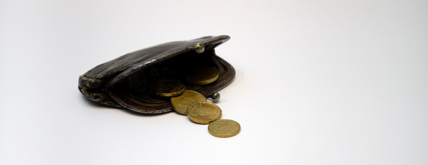 An old leather wallet with metal money on a white background. Round coins in a vintage wallet. The...