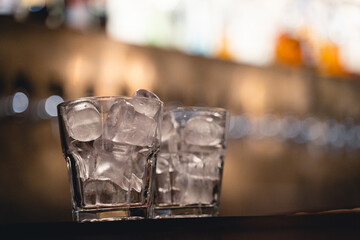 an alcoholic drink with ice is served by the bartender at the bar
