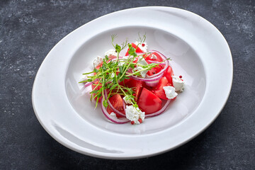 Salad with tomatoes and cheese on a plate