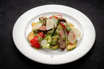 Salad with veal, roasted vegetables, and Parmesan cheese