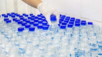 Hand of quality inspector water bottling line for processing and bottling pure drink water