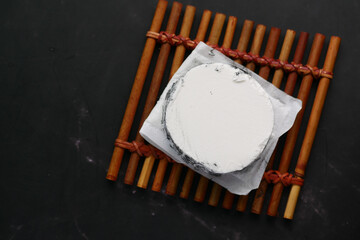 fresh goat cheese and grape fruit on wooden background.