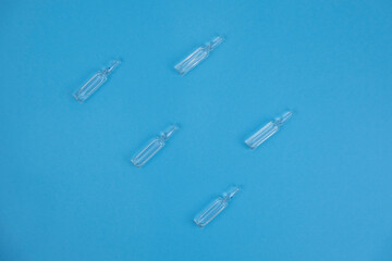 ampoules for injection on a blue background. cosmetology and medicine