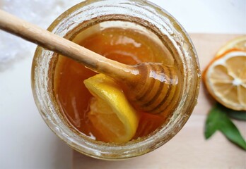 Honey with lemon and wooden spoon