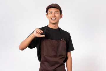 Handsome barista asian man wearing brown apron and black t-shirt isolated over white background pointing yourself with fingers