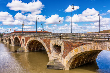 Scenic view of old bridge in Toulouse against spring dramatic sky